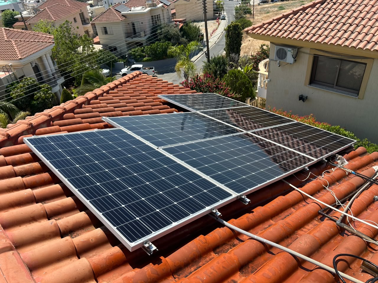 Clean, glossy solar panels on a Cyprus tile roof after professional cleaning